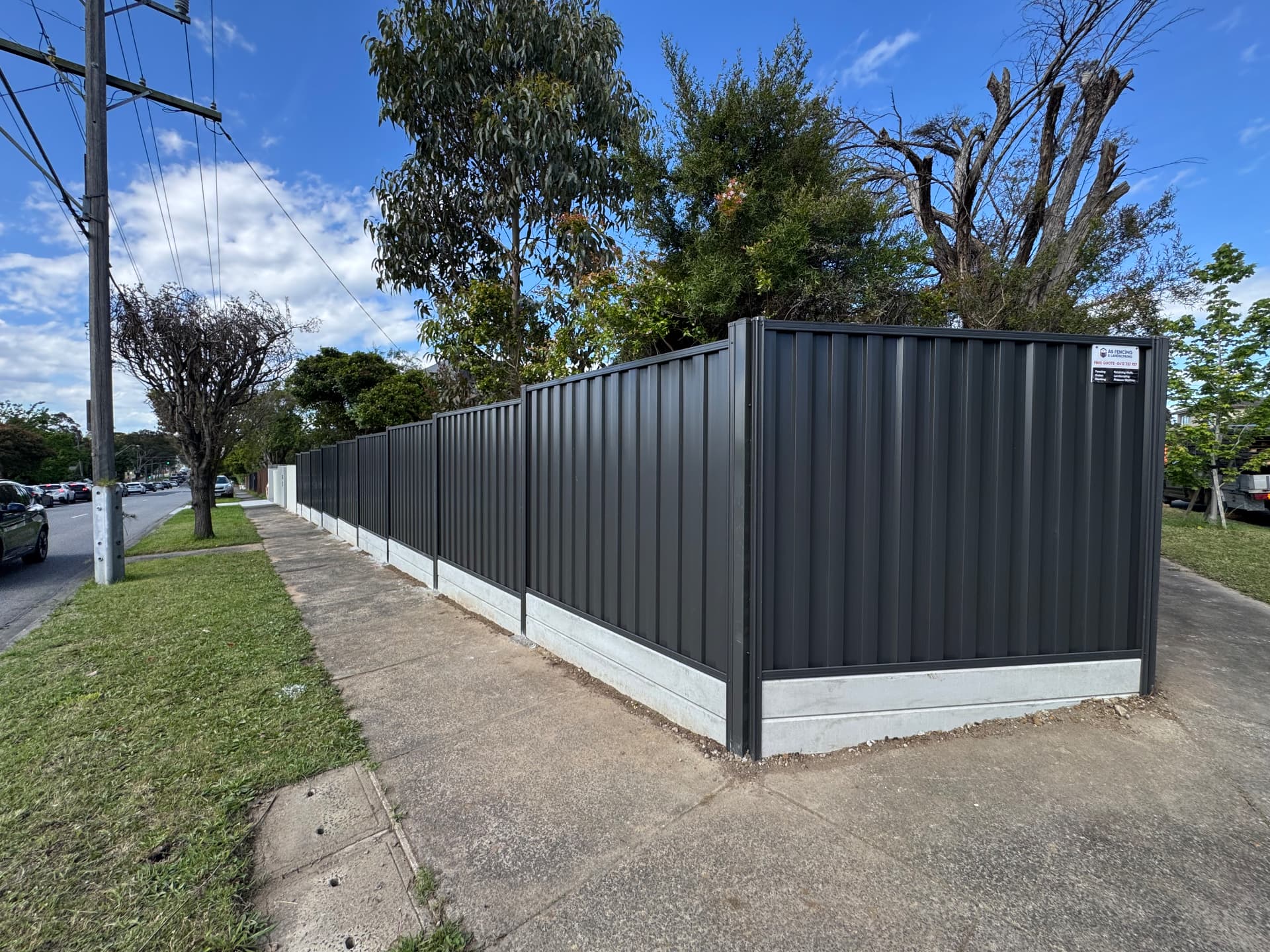 Corner run of charcoal Colorbond fencing on a street frontage